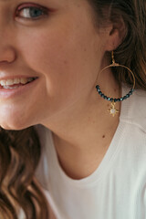 Close up face portrait of young woman with earring 