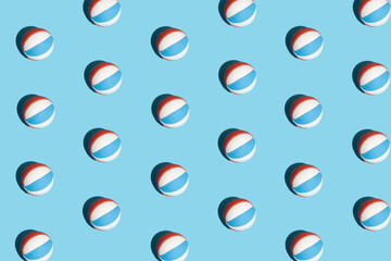 Seamless pattern made of beach ball on pastel blue background. Summer, sport, leisure and friends concept.