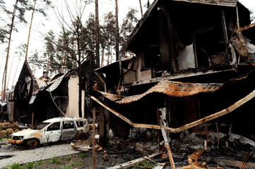 burned house from a rocket attack. Russian invasion of Ukraine. Russia's war against Ukraine. destroyed multi-storey building in ukraine. big fire in the house. burnt car