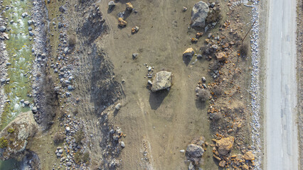 Top view of the road in the mountains and the river. Shooting from a quadcopter. View from above. Drone photography.