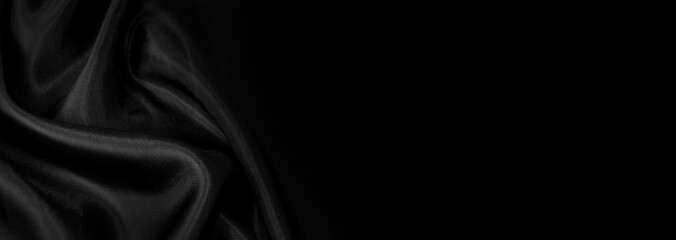 Part of the dark fabric texture of the fabric for the background and decoration of the work of art, a beautiful crumpled pattern of silk or linen. A crumpled piece of cloth