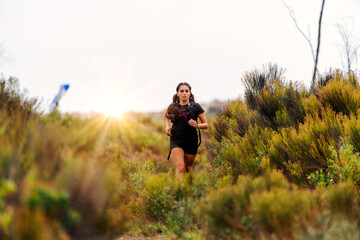 latin young woman doing trail running