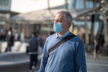 Fototapeta na wymiar Masked man walking outdoor to go at work, coronavirus people lifestyle concept