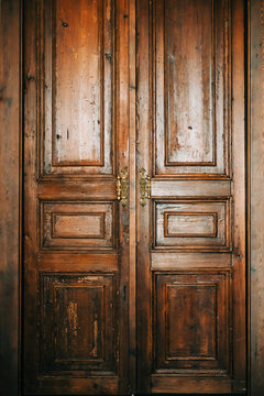 Old vintage wooden door with golden handles.