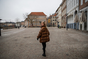 Young girl strolls through the streets of Copenhagen during the winter