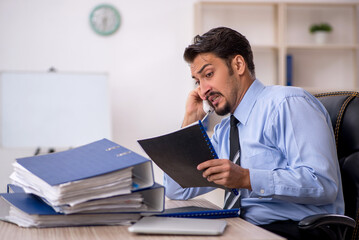 Young male employee working in the office