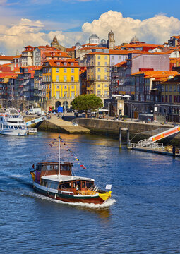 Porto Portugal. Pleasure boat at river Douro. View at old town with authentic house. Picturesque landscape vintage Europe.