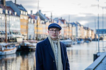 Fototapeta premium Portrait of an elegant young boy in Nyhavn, Copenhagen, the Danish capital, during a winter day