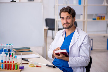 Young male chemist working at the lab