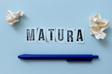Matura text (polish word for end of school exam) written on piece of paper with pen.
