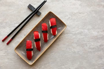  Vegan sushi nigiri style meal with red pepper slices instead of tuna fish. © Fotema