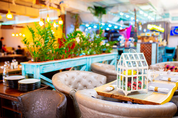 Christmas decorations in the interior. Festive background. New Year's room design, beautiful and shiny toys on the Christmas tree. Blurred background with copy space for text.