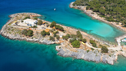 Aerial drone photo of iconic Aponisos bay and lake with clear turquoise sea and pine trees,  Agistri island, Saronic gulf, Greece