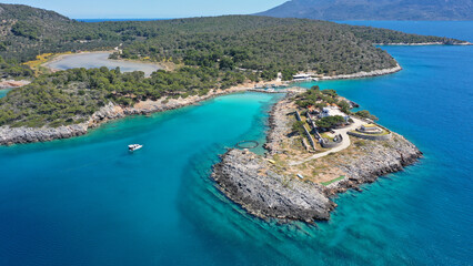 Aerial drone photo of iconic Aponisos bay and lake with clear turquoise sea and pine trees, ...
