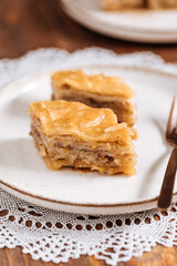 Turkish or Bosnian dessert called Baklava with on a wooden board. Popular dessert for Ramadan and...