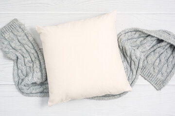 White blank pillow mockup, cozy winter composition with and warm wool scarf, square pillow case,...