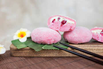 delicious japanese cuisine dessert mochi pink brownies with butter cream and currants with bumbu leaves
