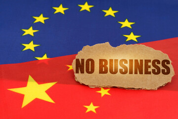 On the flags of China and the European Union lies a cardboard plate with the inscription - No Business