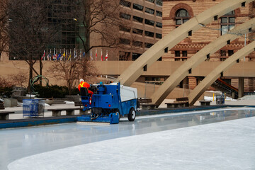 Ice cleaning machine servicing rink in Toronto downtown square