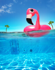 Inflatable flamingo buoy pool underwater split photo - obrazy, fototapety, plakaty