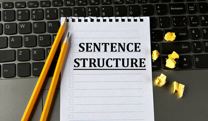 SENTENCE STRUCTURE - words in a white notepad on the background of a laptop with pencils - obrazy, fototapety, plakaty