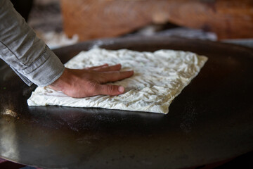 Fototapeta na wymiar A woman making pancakes in Antalya, Turkey. SELECTİVE FOCUS