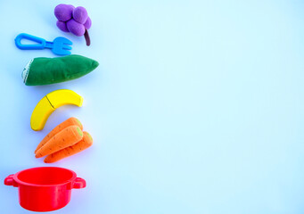 toy fruits with the colors of the LGTBIQ+ collective flag on a white background.