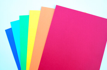 Poster boards with the colors of the LGTBI flag on a white background.