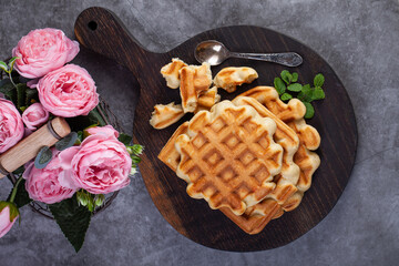 Homemade freshly baked belgian waffles with mint leaves on dark background. - 501011118