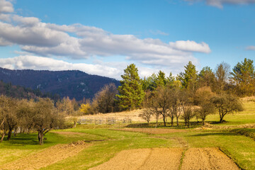 Fototapeta na wymiar Rural mountainous landscape scenery in spring time. Fields and meadows with a background of hills.
