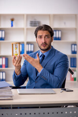 Young male employee in wheel-chair in time management concept