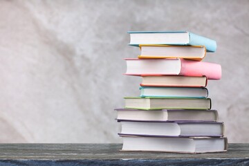 Stack of books on wooden desk