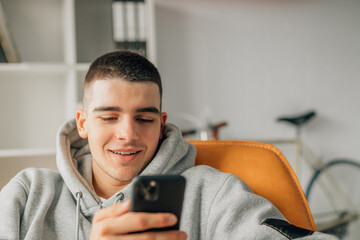 young teenager at home looking at mobile phone
