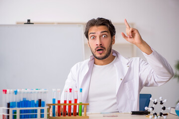 Young male chemist working at the lab