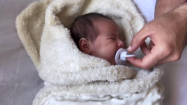 Sweet peaceful baby lying on a white bedsheet enjoy daytime nap