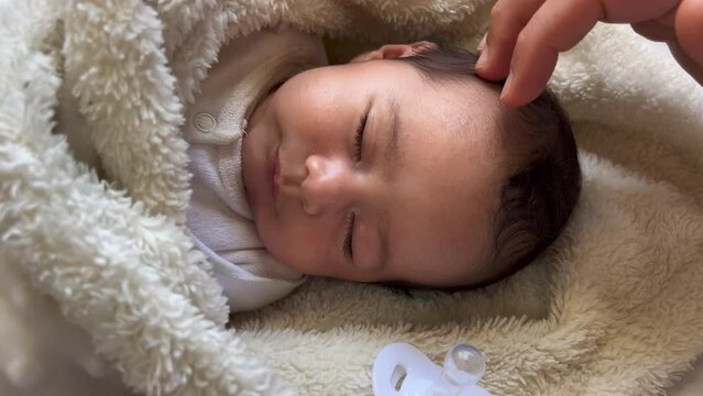 Sweet peaceful baby lying on a white bedsheet enjoy daytime nap