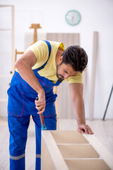 Young male carpenter working at home