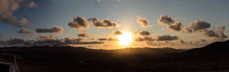 Fototapeta na wymiar Sunset golden clouds, Panoramic photo, Fuerteventura canary islands