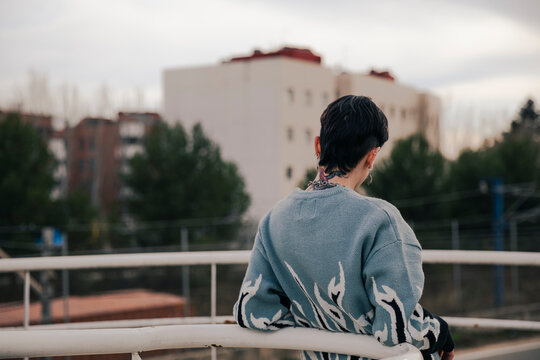 Unrecognizable girl with a tattoo looking at the horizon