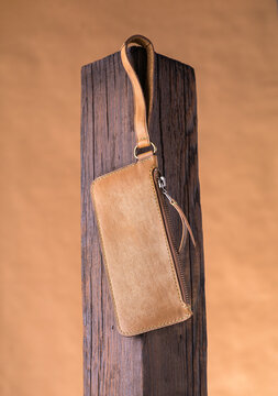 Leather wallet in an epic perspective on a wooden podium