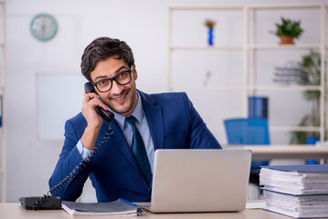 Young businessman employee and too much work in the office