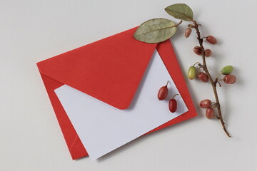 Romantic feminine mockup / stationery, with red envelope on white, white blank sheet of paper and...