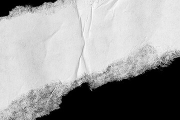 piece of torn white paper on a black isolated background