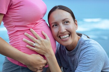 Two lesbian married women expecting a baby. Pregnancy and surrogacy.