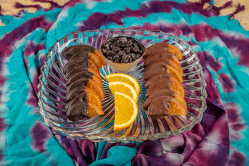 Chocolate candied orange slices. Seasonal candies and sweets, citrus fruit dipped in chocolate and homemade sweet treat concept with close up on candied orange peel, raw oranges and chocolates.