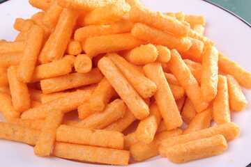 Close up photo of a pile of balado sticks on a white plate. selective focus