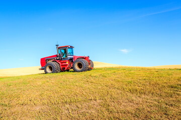 Agricultural tractor in the palouse hill with blue sky background 