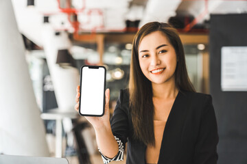 Mockup image of a beautiful brunette Asian woman shows mobile phone with blank white screen.