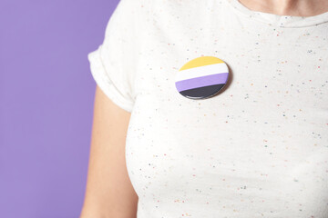 Person with a non binary flag badge; gender diversity, identity pride