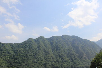 青空の下にある、稜線が複雑な山の風景